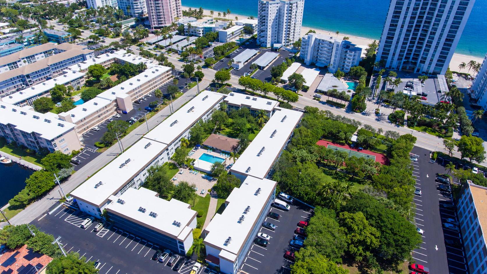 Aerial view showing the property just across from the beach and shoreline